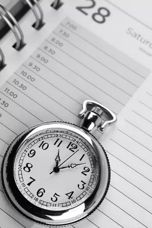 Image of a pocket watch on a calendar